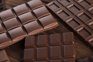 Chocolate bar, candy sweet, dessert food on wooden background