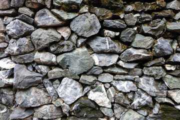 Real stone wall texture background stacked layers are uneven