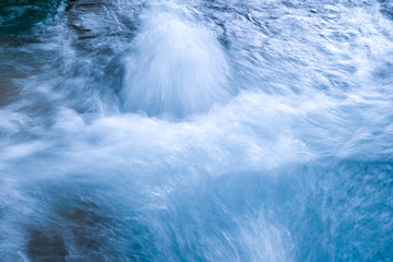 The water massage gushing rapidly in blue pool.