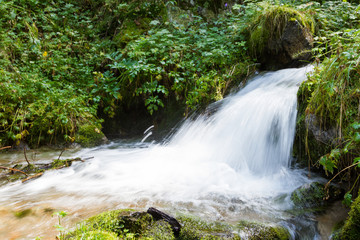 Waterfall in the forest with splashes
