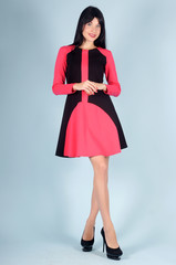 Beautiful young girl  posing on a blue background