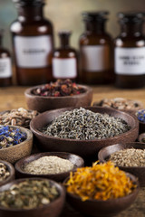 Herbs medicine and vintage wooden desk background