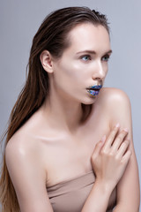 Fototapeta premium Beauty Woman with Perfect Makeup. Beautiful Professional Holiday Make-up. Purple Lips and Nails. Beauty Girl's Face