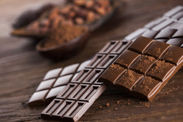Bars Chocolate , candy sweet, dessert food on wooden background