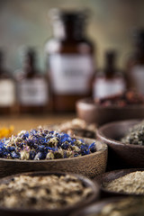 Herbs medicine and vintage wooden desk background