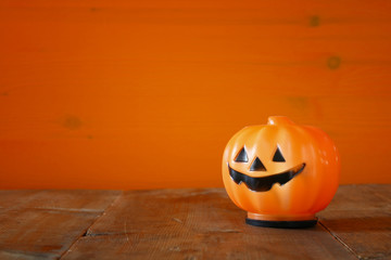 Halloween concept. Cute pumpkin on wooden table