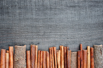 Wooden background with cinnamon sticks