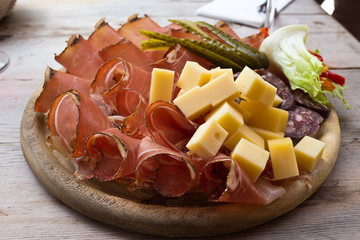 Speck and cheese cold cuts platter - South Tyrol. The plate after alpine trekking: typical food - Puster Valley
