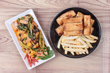 Chinese Vegetable festival  food as fried basil with mixed vegetables served deep fried spring roll and French fries 
