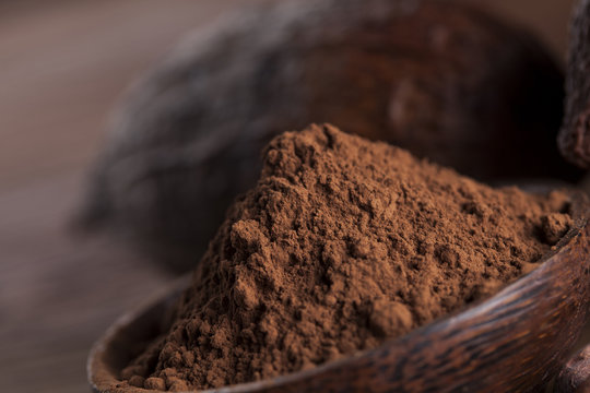 Chocolate bar, candy sweet, cacao beans and powder on wooden bac