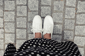 Concept picture of legs walking, Selfie of feet in white sneaker