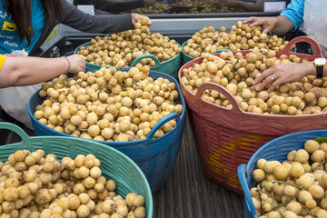 Longkong on scales , Customers are buying Longkong fruit (Lansium )