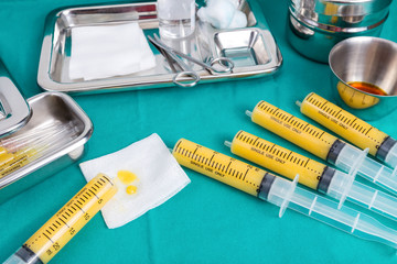 fat in syringes for fat grafting on sterile green fabric