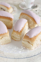 Iced buns or fingers a brioche style bun covered with pink icing