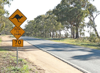 black and yellow kangaroo warning sign on a country road in Australia
