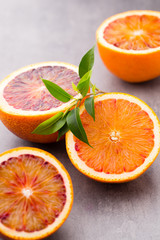 Mixed citrus fruit figs, limes on a gray background.