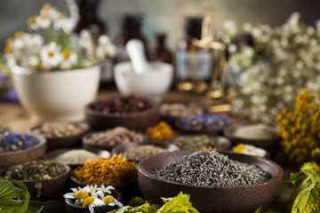 Natural medicine, herbs, mortar on wooden table background