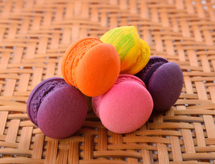 Colorful macaroons, delicious French pastries, stacked on table
