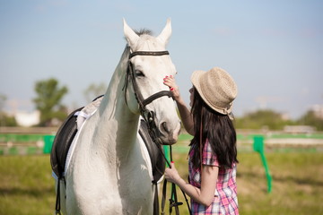 Woman and horse. Portrait close up, pink plaid shirt