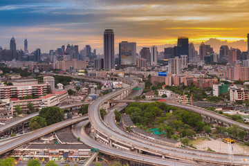Fototapeta na wymiar Top view, highway interconnection with city office building and after sunset sky background
