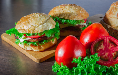 Close-up of home made tasty burgers on wooden table