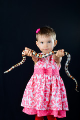 Little girl and milk snake in the studio