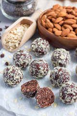 Healthy homemade paleo chocolate energy balls on parchment, vertical