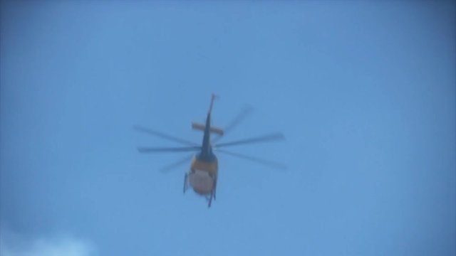 A fire rescue helicopter makes a drop over a hillside fire in Southern California. HD 1080.