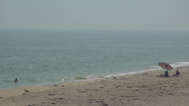 Wide view of beachgoers view of Ho Hum beach on Fire Island
