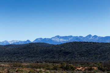Brown to green to almost silver mountain range in De Rust
