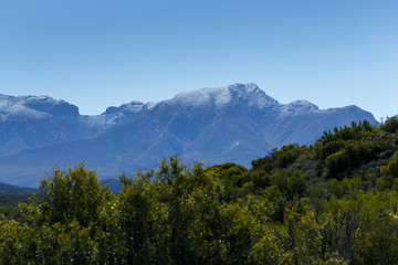 Green Landscape with silver snow filled mountain range in De Rus