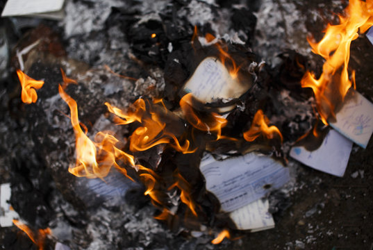burning paper letters closeup. envelopes and letters on fire