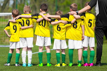 Youth sports team. Young players standing together with coach manager. Youth and sports; team spirit