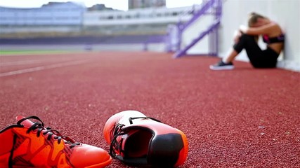 Teenager girl athlete taking breath tired exhausted disappointed after running on a stadium