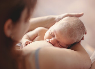 Mother breastfeeding her newborn child. Mom nursing baby. - obrazy, fototapety, plakaty