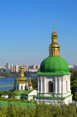 Fototapeta na wymiar Orthodox Christian monastery, Pechersk Lavra in Kiev on green hi