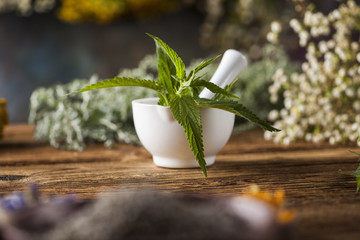 Obraz na płótnie Canvas Fresh medicinal, healing herbs on wooden