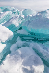 Ice chunks of blue ice is covered with snow