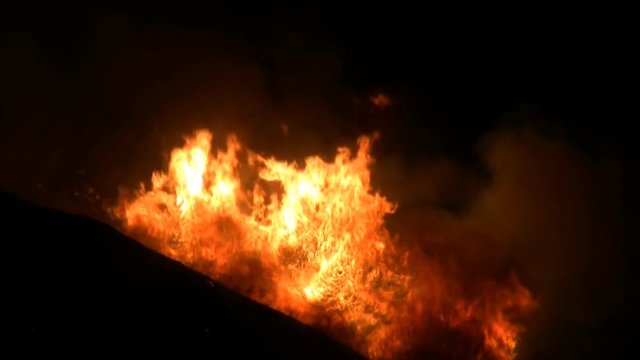 An out of control wildfire blazes through Southern California at night. HD 1080.