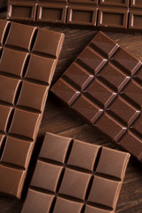 Chocolate bar, candy sweet, dessert food on wooden background