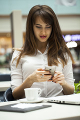 Young beautiful business woman reading messages