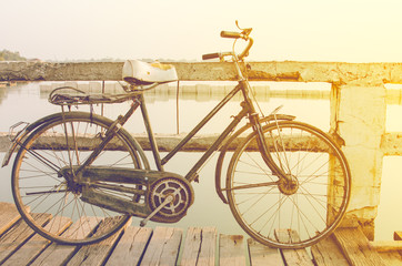 Rusty bicycle retro on wooden bridge with vintage style
