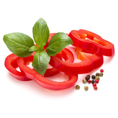 Red sweet bell pepper slices and basil leaves isolated on white