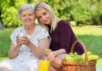 Elderly woman and young woman at the picnic.