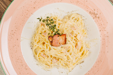 pasta carbonara italian food in a rustic restaurant setting