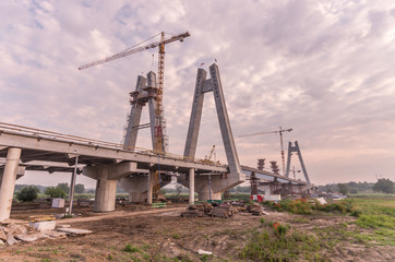 Fototapeta na wymiar Cable stayed bridge under construction in the morning