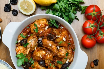 Fototapeten meal of chicken tagine stew in a spicy, nutty tomato sauce and prunes © fazeful