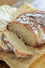 Sliced bread with sesame seeds on parchment paper