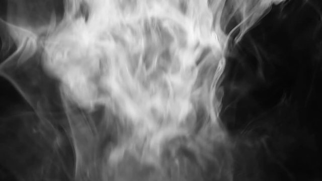 An isolated studio shot of falling steam over a black background.