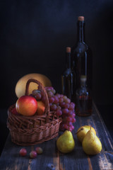 Fruit in a basket,  melon and bottles with wine in style  rustic